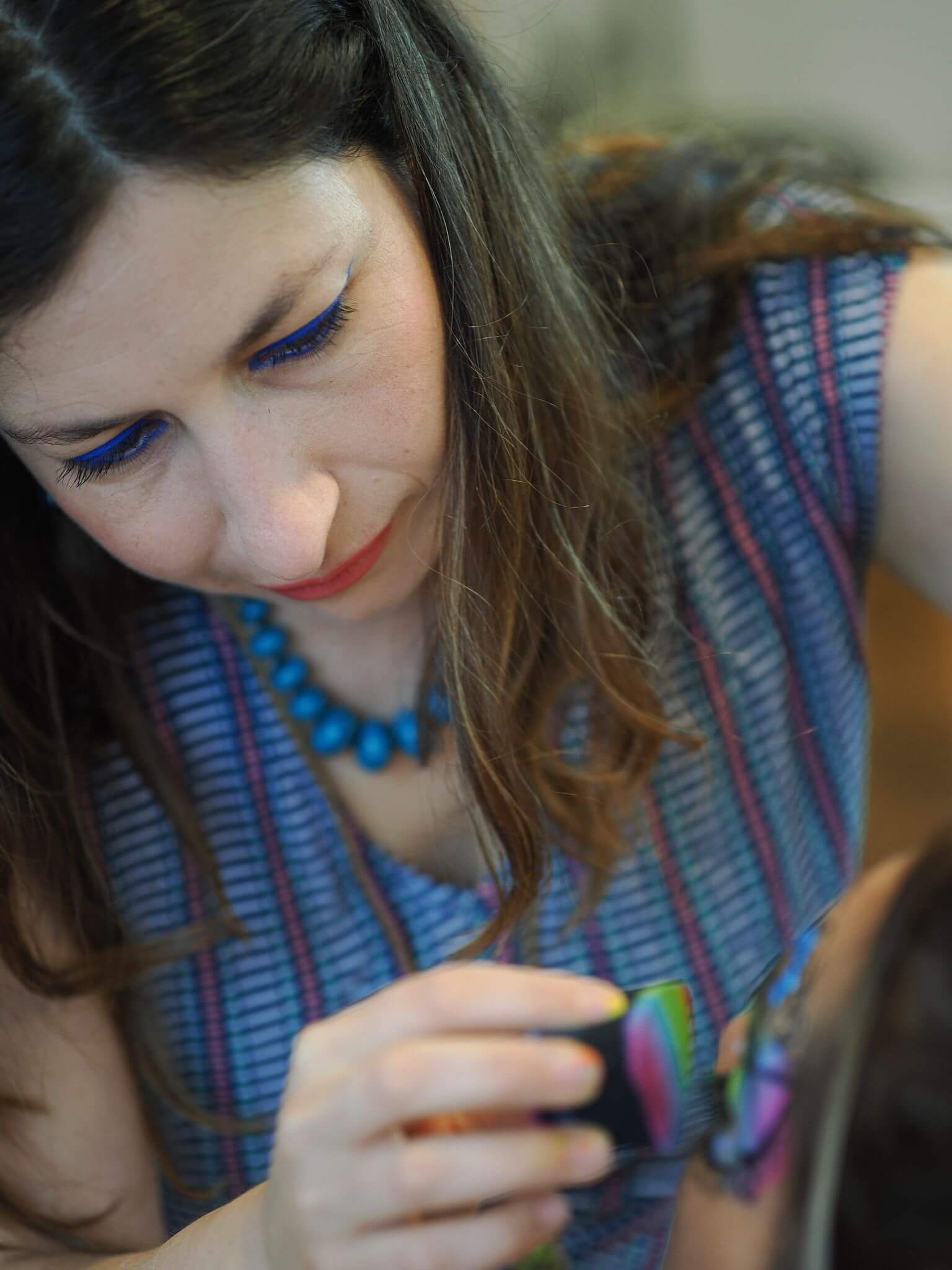 Face painter in Vancouver painting a rainbow on the model's eyes